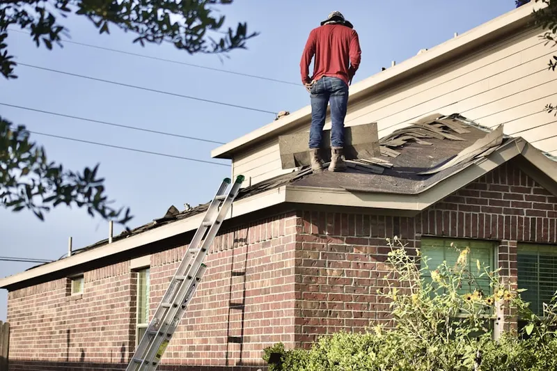 Professional roofer working on a residential roof in North of Mission Drive